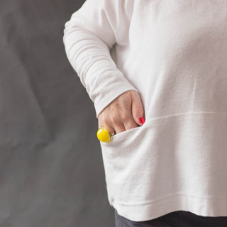 Close up of Female with hand in pocket of the Julia Pocket Top sewing pattern