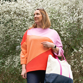 female smiling wearing the origami sweatshirt sewing pattern