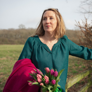 Female wearing the imogen top sewing pattern in teal laundered linen